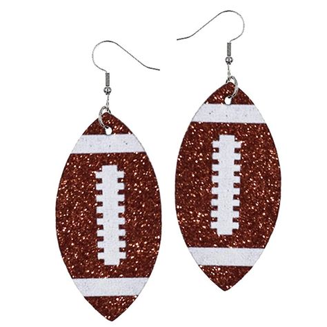 PRICES MAY VARY. Silicone plug closure Football earrings for women for those who wear their passion for football league. This single-layered faux PU football mom accessories are symbolic to our love for football. Wear them in style and style them with pride. The glittering layer of these leather football jewelry would give an added edge to your look. Grab this mocha football jewelry today for yourself or gift it to your bestie. Style: Everyday danglers, Sports love Material: Silver plated with f Team Mom Football Gifts, Team Mom Football, Team Mom Gifts, Football Jewelry, Mom Earrings, Football Accessories, Football Earrings, Glitter Jewelry, Mom Accessories