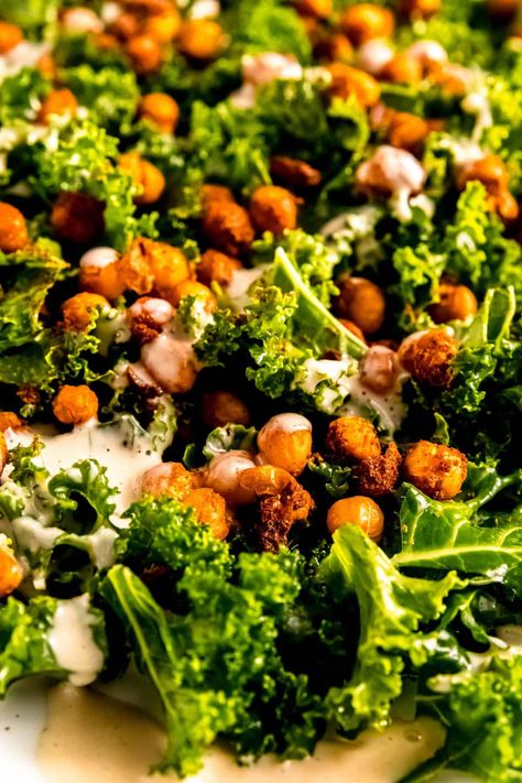 45 degree angle closeup shot of chickpea tahini fall salad showing the contrast of dark green with the reddish gold of the tandoori chickpeas and pale tan hue of the garlic tahini dressing. Chickpea Tahini, Fall Kale Salad, Salad With Tahini Dressing, Fall Salad, Pale Tan, 45 Degree Angle, Crispy Chickpeas, Autumn Salad, Winter Salad