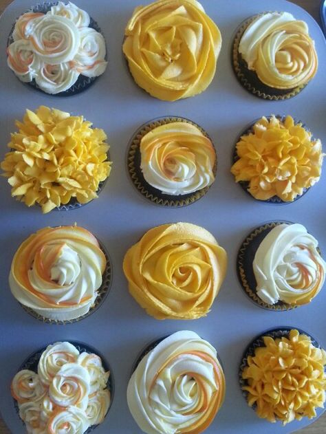 Yellow, orange and white cupcake garden.  Cupcake Roses: hershey's chocolate recipe with vanilla buttercream icing Yellow Frosting Cupcakes, Yellow Icing Cupcakes, Yellow Frosted Cupcakes, Orange And White Cupcakes, Red And Yellow Cupcakes, Yellow Cupcakes Decoration, Cupcake Roses, 45 Anniversary, 60th Birthday Cupcakes