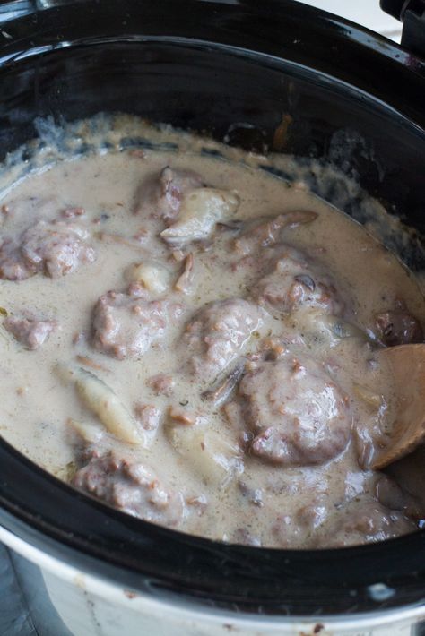 I LOVE this SLOW COOKER Salisbury Steak With Cream of Mushroom Soup! This CROCKPOT recipe is easy to make and is ready in 5 hours! It's made with dry onion soup mix and cream of mushroom soup to make a comforting gravy your entire family is going to love! I always serve on egg noodles or with mashed potatoes! This is one of my favorites simple weeknight meals! Salisbury Steak Recipe With Cream Of Mushroom Soup, Salisbury Steak Recipe Easy Cream Of Mushroom Soup, Round Steak Recipes Crock Pot Cream Of Mushroom Soup, Salisbury Steak Frozen Meatballs Crockpot, Crockpot Salisbury Steak Recipe, Crockpot Salisbury Steak With Frozen Hamburger Patties, Crockpot Salisbury Steak, Simple Weeknight Meals, Salisbury Steak Crockpot