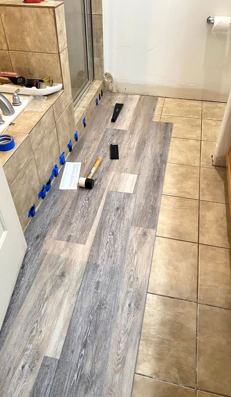 Learn how to install waterproof vinyl planks over existing flooring! Vinyl Flooring Wall Ideas, Diy Vinyl Wood Flooring, Lifeproof Bathroom Floor, Luxury Vinyl Plank Over Ceramic Tile, Laminate Over Tile Floor Bathroom, Laying Vinyl Flooring Over Ceramic Tile, Lifeproof Vinyl Flooring Bathroom, Vinyl Plank Flooring Ideas House, Vinyl Plank Over Tile Floor