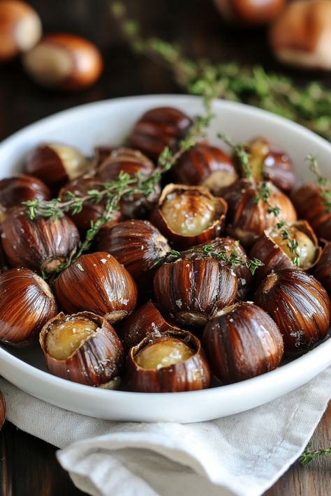 Roasted chestnuts garnished with fresh thyme in a white bowl. Roasted Chestnuts Oven, Holiday Side Dishes Christmas, Spiced Hot Chocolate Recipe, Honey Ham Glaze Recipe, Stuffing Balls Recipe, Maple Roasted Carrots, Easy Holiday Side Dishes, Chestnut Recipes, Ham Glaze Recipe