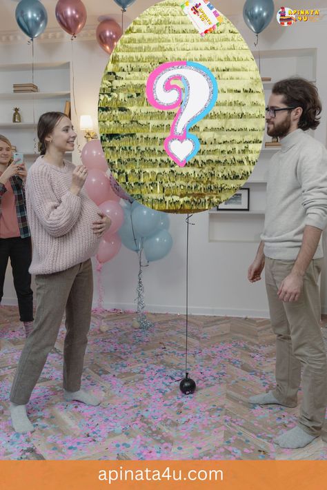 A couple celebrating a gender reveal party faces a large golden egg piñata with a colorful question mark on it. The floor is sprinkled with pink and blue confetti, and balloons in similar colors float behind them. The pregnant woman smiles while holding her belly, and a friend is taking photos in the background. Cute Questions, Easter Gender Reveal, Easter Theme Party, Gender Reveal Unique, Question Mark, Easter Sunday, Easter Party, Reveal Parties, Gender Reveal Party