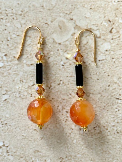 Carnelian Earrings featuring a 20MM shaded carnelian faceted round stone accented with gold plated bead caps, a black onyx smooth tube bead and 6MM smoke topaz a/b bicone crystals.  Gold filled ear wires.  earrings measure 1 3/4 inches.  Handmade GIFT BOXED Crystal Bead Earrings Diy, Small Handmade Earrings, Gemstone Bead Earrings, Diy Earrings Video, Bead Earrings Diy, Handmade Bead Jewellery, Carnelian Earrings, Diy Jewelry Earrings, Beaded Jewelry Necklaces