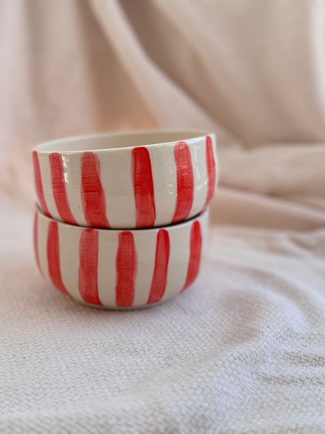 Indulge in the luxury of Mediterranean summers with our Striped Bowl. Handcrafted with white clay and detailed with hand-painted red stripes, these bowls are the perfect addition to your summer table. Enjoy a fresh salad or a refreshing fruit mix and transport yourself to a breezy seaside escape. •1 per order •each piece is handmade and will have slight variations to another. • dishwasher safe, however handwashing is recommended for best care. Hand Painted Dinnerware, Hand Painted Pottery Bowls, Ceramics Bowls, Painted Bowls, Ceramics Bowls Designs, Striped Bowl, Pottery Inspo, Bowl Pottery, Hand Painted Bowls