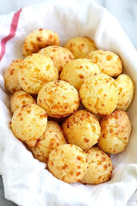 Easy and delicious homemade Brazilian cheese ball puff pastries in a basket. Brazilian Cheese Puffs, Cheese Puffs Recipe, Brazilian Cheese Bread, Puff Recipe, Cheese Puffs, Brazilian Food, Simply Recipes, Cheese Bread, Bread Rolls