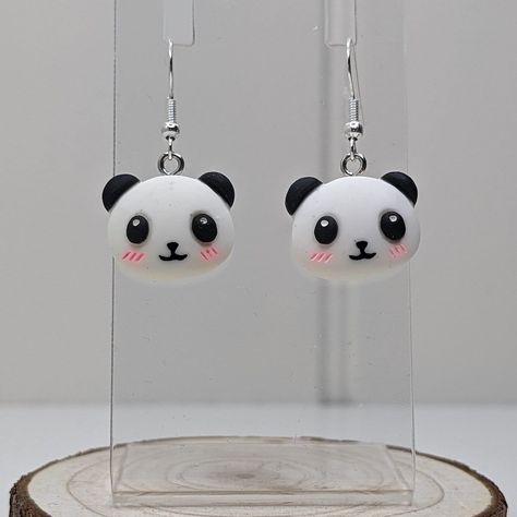 Whether a treat for yourself of a gift for a loved one, these cute kawaii panda earrings are the perfect statement earrings for expressing yourself.  The Earrings. These earrings are made of stainless steel and polymer clay. The measurements of these earrings are: Pendant Height: 1.6cm Pendant Width: 2cm Full Drop: 3.7cm Each pair of our earrings have been lovingly made and may vary slightly in colour, pattern and size to the displayed image. Dispatch and Delivery. Please allow 1-2 working days for your item/s to be dispatched. All items will be posted in letterbox friendly packaging with free second class postage to UK mainland (England, Scotland, Wales and Northern Ireland) addresses only. If you have any questions please do message and we would be more that happy to help in assisting yo Panda Polymer Clay, Polymer Clay Panda, Panda Earrings, Affordable Earrings, Earrings Kawaii, Novelty Earrings, Kawaii Panda, Quirky Earrings, Unusual Jewelry