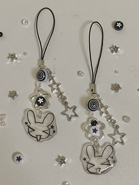 🎼super cute handmade beaded + shrinky dink bunny phonecharm 🎹handmade with love and packaged with care :D 🖤make sure to keep product away from water and avoid tugging on it aggressively! 🤍thanks for visiting my shop How To Make Shrinky Dink Key Chains, Stargirl Accessories, Shrink Dink Keychain, Shrinks Dink Ideas, Shrink Charms, Shrinky Dink Charms, Shrinky Dink Ideas, Shrinky Dink Keychain, Shrinks Dink