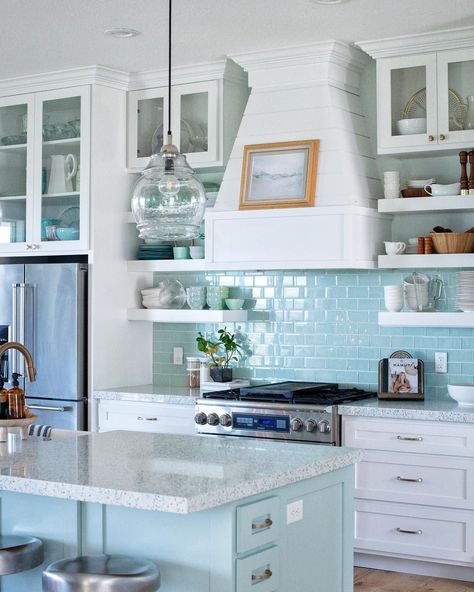 Tile backsplashes can make all the difference in a kitchen. This glass tile is truly the wow factor in this coastal kitchen. Blue Kitchen With White Cabinets, Coastal Blue Kitchen, Kitchen Shiplap, Blue Tile Backsplash Kitchen, Farmhouse Kitchen Backsplash Ideas, Blue Backsplash Kitchen, Kitchen With White Cabinets, Aqua Kitchen, Light Blue Kitchens