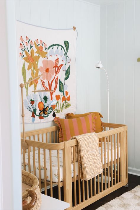 Our daughter's colorful, garden themed nursery. Love Bug Nursery, Nestig Crib Nursery, Nestig Wave Crib, Fun Nursery Ideas, Bird Themed Nursery, Colorful Nursery Ideas, Garden Themed Nursery, Wave Crib, 70s Nursery