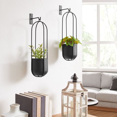 Summer home decor just got better with these stunning wall planters! Meet the Walter 2-Piece Modern Black Metal Oval Hanging Planter Set. Say goodbye to bare and boring walls, and hello to these modern planters. Hang them in your living room, bedroom, kitchen, or garden to add some greenery! #danyabhome #homedecor #interiordesign #homestyle #interiorinspo #wallplanters #modernhomedecor #modernminimalism Metal Hanging Planters, Guest Room Decor, Modern Planters, Bathtub Accessories, Hanging Frames, Hanging Planter, Summer Home Decor, Affordable Home Decor, Wall Planter