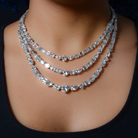 This spectacular three-row 150.16 CTTW necklace set in 18kt white gold is sure to turn heads. Unique and one-of-a-kind, this statement necklace features 149 lab grown diamonds in a mix of five beautiful shapes: cushion, pear, heart, oval & radiant. Hand-selected to maximize sparkle, the necklace is sure to captivate and charm. The 16.5" length is a perfect fit for any occasion.  Cushion: 3 stones, 10.09 CTW Pear: 44 stones, 33.95 CTW Heart: 6 stones, 6.21 CTW Oval: 48 stones, 37.98 CTW Radiant: 48 stones, 61.93 CTW Color Range: D-G Clarity: VVS2 - SI1 Please note: This item is one of a kind and we can not customize this piece for you or make any alterations. We can create a custom version by working with our design team. Layered Diamond Necklaces, Lab Grown Diamond Necklace, Diamond Necklace Set Bridal, Harry Winston Diamond Necklace, Jewelry Design Sketch, Diamond Headpiece, 3d Jewelry Design, Beautiful Diamond Jewelry, Expensive Necklaces