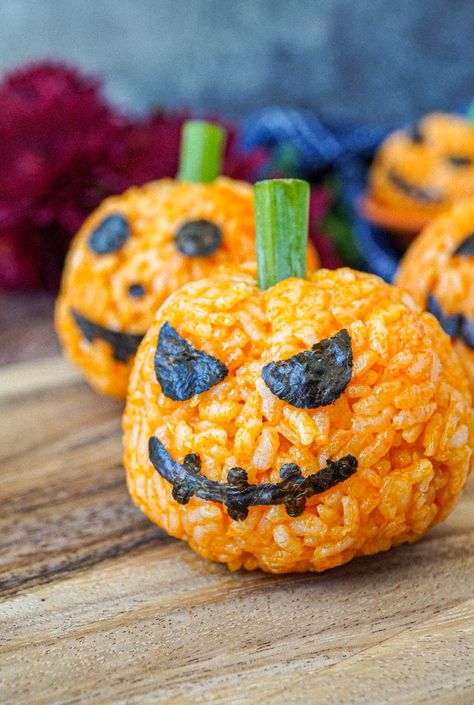 Close up of Jack-O-Lantern Carrot Rice with nori face and green onion stem. Carrot Rice, Numi Tea, Turmeric Rice, Recipe Rice, Artificial Food, Jack O Lantern Faces, Carrot Juice, Rice Balls, Green Onion