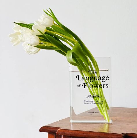 PRICES MAY VARY. Versatile design: Our acrylic book vase is not just a stylish bookend, but also a functional vase for small bouquets of flowers. Unique charm: With its clear design, this book vase showcases the beauty of literature in a one-of-a-kind way. Perfect size: Measuring 8.3 x 5.5 x 2 inches, our book vase is perfectly sized for use as a bookend or a vase for small bouquets. Durable materials: Made from high-quality acrylic, this book vase is built to last and can withstand everyday wea Book Vase, Unique Flower Vases, Bloom Book, Craftsman Decor, 2025 Christmas, Bouquets Of Flowers, Minimalist Home Office, Vase Clear, Acrylic Vase