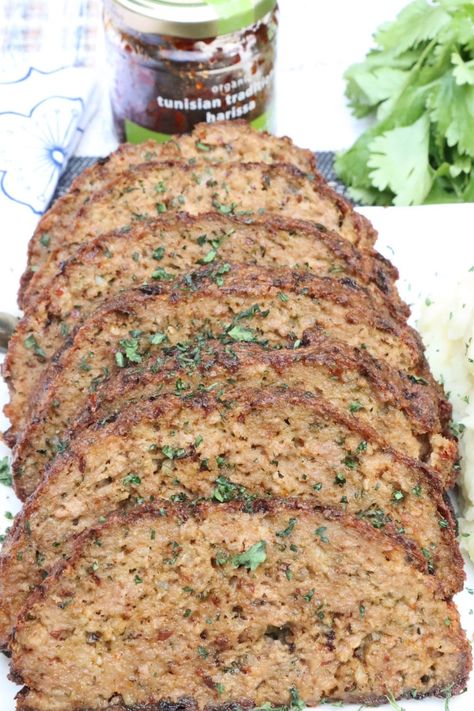 sliced harissa lamb meatloaf on a platter garnished with parsley Lamb And Beef Meatloaf, Lamb Meatloaf, Harissa Lamb, Ground Beef Meatloaf, Ground Lamb Recipes, Meatloaf Burgers, Beef Meatloaf, Lamb Burgers, Harissa Paste