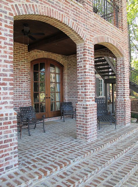 Arches and columns bring light and air into this backyard oasis. Brick stairs built with mortared pavers in a basket-weave pattern give the patio an extra touch of elegance. http://insistonbrick.com/ Exterior Brick House Colors, Brick Paint Colors, Brick House Colors, Brick House Exterior, House Columns, Brick Porch, Brick Companies, Brick Columns, Brick Arch