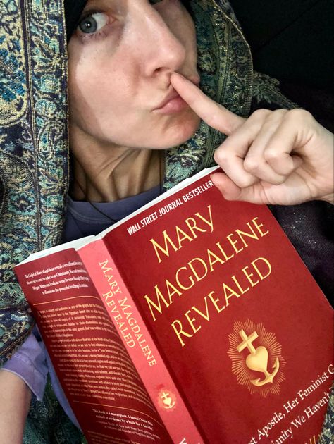 Image: a woman holding the book “Mary Magdalene Revealed” by Meggan Watterson. The woman is making a shush gesture with her index finger to her lips, inviting the reader to come with her on this secretive journey to discover this sacred text that has been removed from the canonical bible. Gospel Of Mary Magdalene, Books Recs, Egyptian Desert, The Gospels, Mary Magdalene, The Gospel, Christian Bible, Wall Street Journal, Wall Street