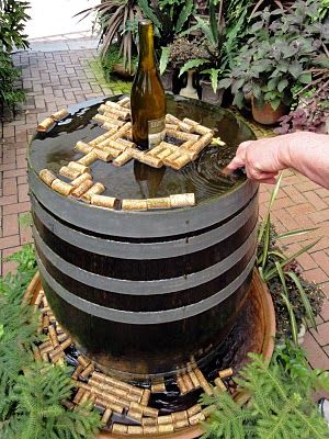 Wine Bottle Fountain, Black Hollyhock, Small English Garden, Bottle Fountain, Patio Water Fountain, Beer Garden Ideas, Barrel Fountain, Ashville North Carolina, Frederick Law Olmsted