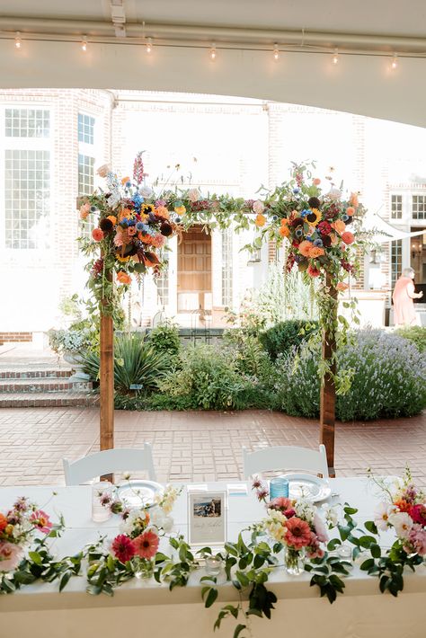 Wildflower Ceremony Decor, Wild Flower Wedding Arbor, Sweetheart Table With Bud Vases, Simple Wildflower Wedding Arch, Sweetheart Table Wedding Wildflower, Wildflower Head Table, Wedding Ceremony Flower Arch, Wild Flower Ceremony, Sweetheart Table Wildflowers