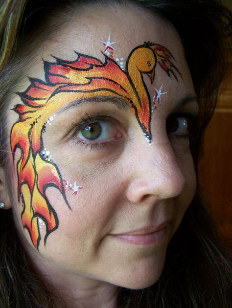 Phoenix Face Painting eye design Phoenix Face, Phoenix Face Paint, Fire Face Paint, School Spirit Face Paint, Animal Face Paintings, Adult Face Painting, Art Tumblr, Girl Face Painting, Hallowen Ideas