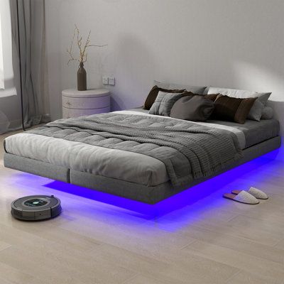 This innovative and modern floating bed frame has a unique hidden foot design that prevents your legs from accidentally hitting the foot of the bed and gives the illusion of a bed floating above the ground, dreamy and light. The highly comfortable suspended design and LED lights complement each other, creating a sense of modern technology for you, while also allowing you to have a unique and novel visual experience. | Ivy Bronx Queen Size Floating Bed Frame w / LED Lights Metal Slats Underbed St Modern Floating Bed, Teen Room Decor For Boys, Bed Floating, Bed Frame With Led Lights, Floating Bed Frame, Foot Design, Underbed Storage, Boy Bedroom Design, Floating Bed