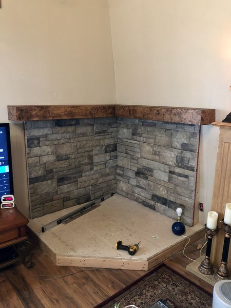 Wood Stove Mantle Corner, River Rock Behind Woodstove, Tv And Wood Stove Layout, Wood Stove With Curved Pipe, Wood Burning Stove Basement, Farmhouse Living Room With Wood Stove, Free Standing Wood Stove Ideas, Woodstove Backing Ideas, Rock Wall Behind Wood Stove