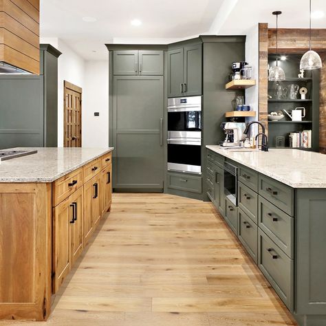 Blend rustic charm with contemporary flair in your kitchen makeover. Let's work together to turn your vision into reality. Contact us today! Stained Cabinets: Showplace Pendleton door | Rustic Hickory | Cognac with Ebony glaze Painted Cabinets: Showplace Lancaster door | Jasper paint . . . #cabinets #kitchen #kitchendesign #kitchengoals #kitchenremodel #mountainmodern #rusticchic #showplacecabinetry Wood And Painted Kitchen Cabinets, Paint Cabinets Kitchen, Jasper Paint, Stained Cabinets, Hickory Kitchen Cabinets, Green Kitchen Island, Hickory Kitchen, Paint Cabinets, Hickory Cabinets