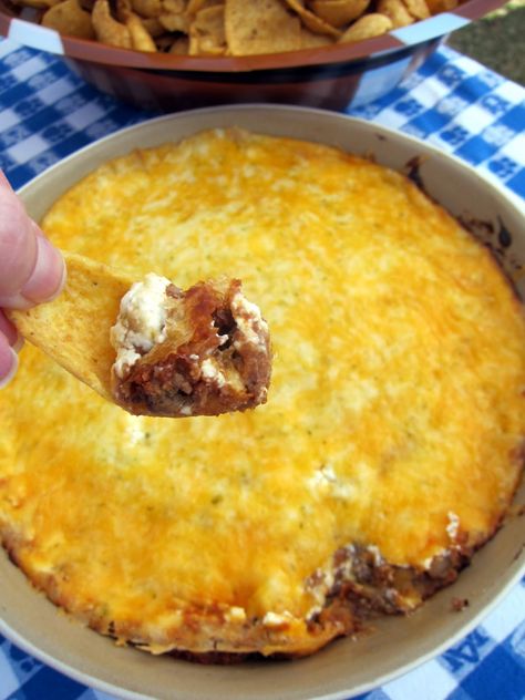 Taco Dip - Football Friday:   1/2 lb ground beef,   1 can refried beans,   1 packet taco seasoning,   8 oz sour cream,   2 C shredded cheddar cheese,    Preheat oven to 350.  Brown beef & drain. Mix beans, cooked ground beef and taco seasoning. Spread bean mixture in bottom of a 9x13" baking dish. Spread the sour cream on top of the beans & top with cheese.   Bake at 350 for 25-30 minutes - until cheese is bubbly. Serve with Fritos. Baked Taco Dip, Gameday Dips, Dip With Ground Beef, Nacho Dip, Taco Bake, Taco Dip, Snack Dip, Mozzarella Sticks, Family Table