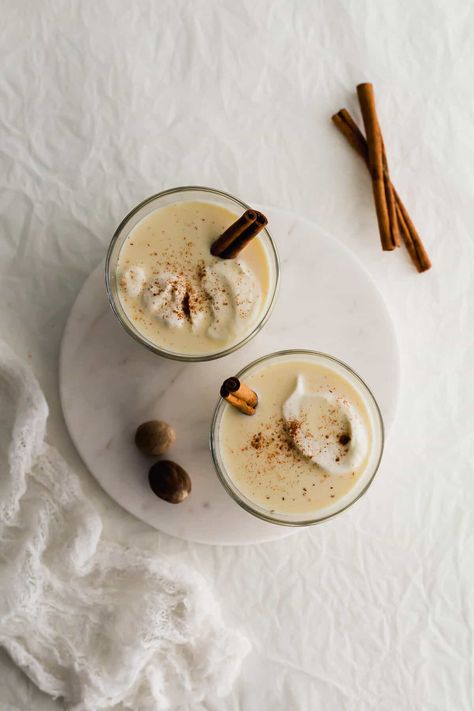 Two glasses of homemade eggnog on a white round marble. What Is Eggnog, Paleo Eggnog, Eggnog Ice Cream, Eggnog Recipe Homemade, Eggnog Latte, Custard Ice Cream, Mini Pavlova, Vietnamese Iced Coffee, Homemade Eggnog