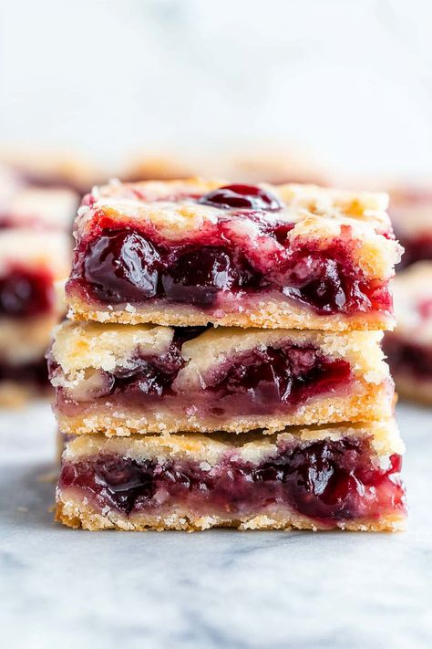 These cherry pie bars are both delicious and visually appealing! They are a homemade treat that's simple to prepare, slices beautifully, and serves effortlessly. Feel free to use any type of pie filling! Is there a sight more charming than a dessert adorned with cherries or strawberries? I adore the vibrant hues and delightful tastes, Tart Cherry Pie Filling Recipes, Gluten Free Cherry Pie Bars, Cherry Crumb Pie With Canned Cherries, Cherry Pie Filling Recipes Easy, Cherry Oatmeal Bars, Cherry Dessert Recipes, Cherry Pie Bars Recipe, Pie Filling Desserts, Cherry Pie Filling Recipes