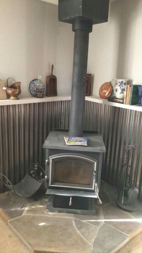 Woodstove Surrounds Metal, Corrugated Metal Fireplace Surround, Wood Stove Surround Metal, Wood Stove Base, Wood Stove Surround Corner, Corner Wood Stove Ideas, Wood Burning Stove Corner, Corner Wood Stove, Wood Stove Surround