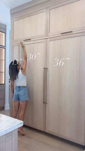 Laura Rustico II Building Beauty Full on Instagram: "You can really tell how short I am in this one 🙈

🤩Sharing our fridge / freezer panelled cabinetry wall. 

One thing I truly love about this wall is the 13” cabinet next to the fridge. It has become our go to place for snacks, everyday essentials and the kids love the easy access. 

I store away seasonal decor in the top two cabinets which include a single pull hardware and lift upwards for some design variety. 

Our fridge and freezer are panelled and overall, I’m really happy with choosing to panel them. I love waking up to the white oak look. 🍃

Here are the full dimensions

Panelled Freezer - 30” x 80”
Panelled fridge - 36” x 80”
Side cupboard- 13” x 80”
Upper lift Cabinets- 46” x 24”

All hardware is linked via https://liketk.it/ Diy Panel Fridge, Refrigerator Wall With Cabinets, How To Hide Deep Freezer, Hiding Deep Freezer, Panelled Fridge, Above Fridge Ideas, Hidden Fridge, Side Cupboard, Above Fridge