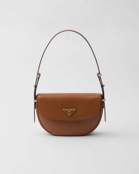 Cognac Prada Arqué Leather Shoulder Bag With Flap | PRADA Prada Arqué Leather Shoulder Bag, Prada Top, Fall Bags, Minimalist Accessories, Bag Details, Fancy Bags, Prada Bags, Wallet Pouch, Triangle Logo