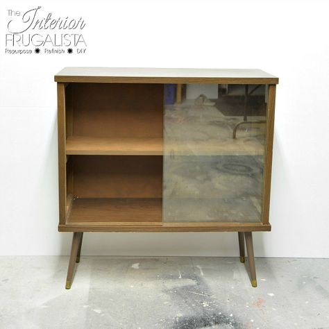 Mid Century Modern Bookshelf With Frameless Sliding Glass Doors Before Makeover | The Interior Frugalista Glass Cabinet Doors Repurposed, Entry Hall Furniture, Funky Bar, Bookshelf With Doors, Modern Cabinet Doors, Mid Century Bookshelf, Mid Century Modern Bookshelf, Cabinet Doors Repurposed, Bookcase Makeover