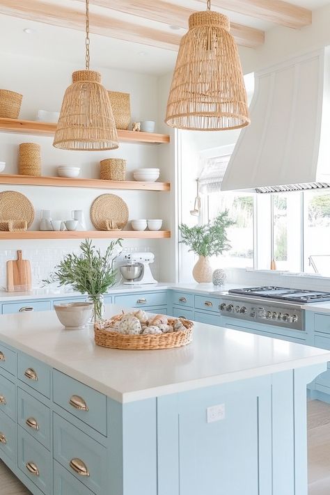 Discover the charm of the latest kitchen design with this serene coastal chic kitchen. Bright blue cabinets, wicker accents, and open shelving create a light, airy space perfect for cooking and entertaining. #kitchendesign #homedecor #coastalliving Boho Bright Kitchen, Light Blue Bottom Cabinets White Top, Coastal Kitchen Appliances, California Coastal Interior Design Kitchen, Grandmillenial Style Kitchens, Coastal Farmhouse Kitchen Design, Coastal Boho Kitchen Ideas, Grand Millennial Style Kitchen, Coastal House Kitchen