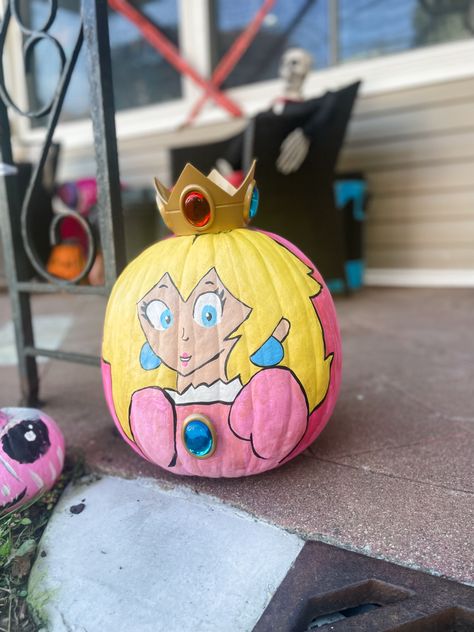 Princess Peach painted pumpkin Princess Peach Pumpkin Painting, Princess Pumpkin Painting, Princess Peach Pumpkin, Book Character Pumpkins, Princess Pumpkin, Princess Painting, Character Pumpkins, Peach Paint, Kindergarten Projects