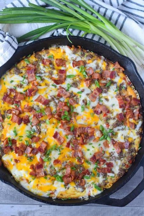 Breakfast casserole in a cast iron skillet with green onions on the side. Iron Skillet Breakfast Recipes, Iron Skillet Breakfast, Dutch Oven Breakfast, Cast Iron Recipes Dinner, Cast Iron Skillet Recipes Dinner, Breakfast Skillet Recipes, Easy Breakfast Casserole Recipes, Easy Breakfast Casserole, Eggs And Cheese