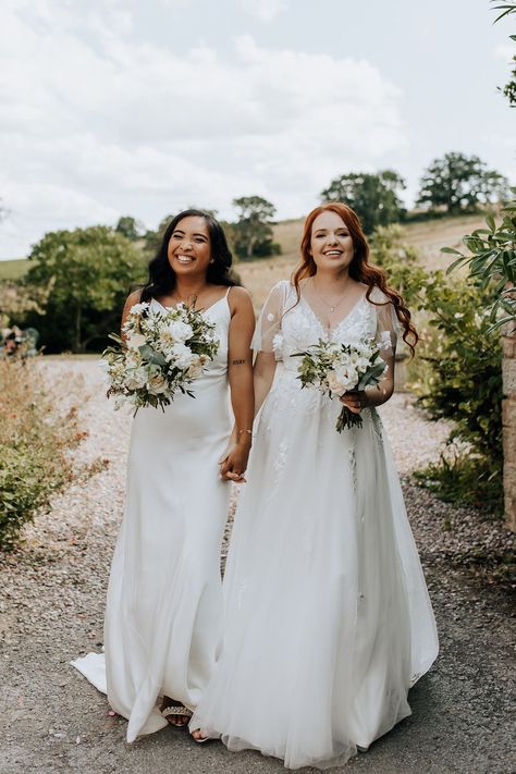 Bride in satin slip wedding dress with the bride in a floral lace princess gown for same sex wedding Lesbian Wedding Dress, Satin Slip Wedding Dress, Whimsical Wedding Dresses, Wedding Dresses Cute, Lesbian Wedding Suit, Wedding Two Brides, Lesbian Wedding Outfits, Slip Wedding Dress, Lesbian Weddings