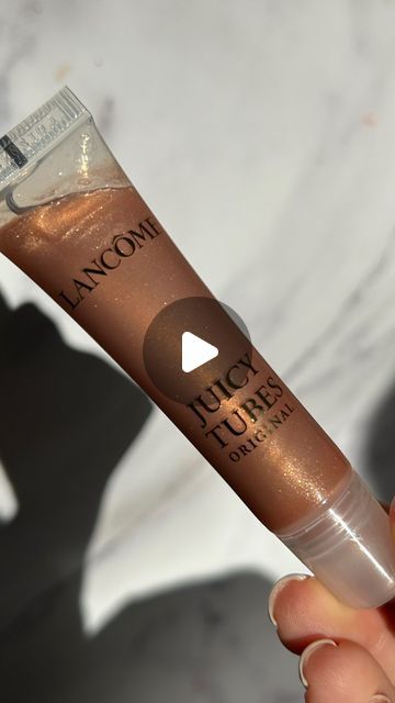 Naomi Mizrahi on Instagram: "So the juicy tube is going viral again… so excited to have this OG back in my life. Bronze heaven ⚡️👑🤎 @lancomeofficial juicy tube “ hallucination,” RRP £25 FYI these glosses are a little sticky (I like this) but if you don’t like sticky this gloss isn’t for you. Please do not use/repost my content without my permission. - - - #lipgloss #viralmakeup #makeup #makeupmacro #makeupunboxing #newmakeup #makeupinspo #makeuplover #cleargloss #lipglossjunkie #lipglossaddict #plumpinggloss #lipplumper #glittergloss #sparkle #shimmergloss #ukblogger #ukinfluencer #ukmakeup #lancome #lancomejuicytubes #juicytube" Lancome Juicy Tubes, Uk Makeup, Glitter Gloss, Going Viral, Lip Plumper, In My Life, Makeup Inspo, Makeup Lover, So Excited