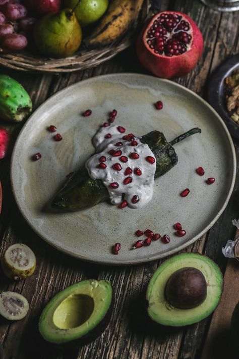 fruit peppers and chiles en nogada on plate Mexican Aesthetic, Walnut Cream, Walnut Sauce, Pine Nut, Golden Raisins, Pomegranate Seeds, Ground Meat, Authentic Recipes, Filling Recipes