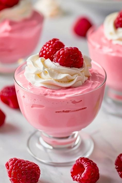 This traditional raspberry mousse recipe uses real raspberries for an intensely fruity flavor. It's pretty in pink, light, airy, and too good to miss. Pink Mousse Cups, What To Do With Mushy Raspberries, Raspberry Parfait Desserts, Recipes Using Raspberry Puree, Easy Mouse Recipes, Pink Foods For Party, Mousse Dessert Recipes, Yummy Recipes Dessert, Fruity Dessert Recipes