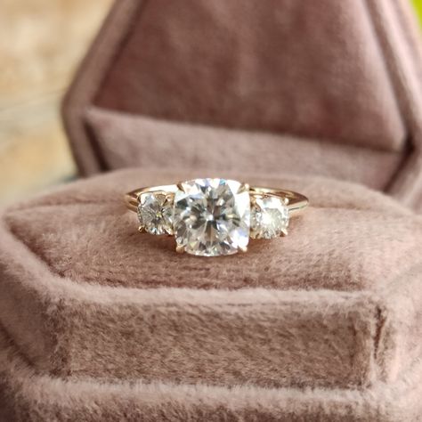 Vintage Three Stone Moissanite Diamond Engagement Ring 14k Yellow Gold Cathedral Setting 2 carat Cushion Cut Engagement Ring with Side Stone, 3 Stone Engagement Rings for Women, 2ct Cushion Cut Moissanite Ring, Three Stone Engagement Ring, Anniversary Ring Gift for Wife, Classic Wedding Ring, Unique Proposal Ring for Girlfriend, Moissanite Jewelry, Bridal Ring, Basket Setting Ring 💎 Center Moisanite Details 💎 ➤Shape: Cushion Cut Moissanite ➤Size: 2.00CT (approx.) ➤Measurement: 7.50x7.50mm ➤Main Stone Clarity: VVS1 ➤Color: D E F ➤Cut Grade: Excellent ➤Moissanite Guarantee: Test Positive By Thermal Diamond Testers & lifetime Brilliance ➤Hardness: Moissanite 9.25 💎 Side Moissanite Details 💎 ➤Shape: Round Cut Moissanite ➤Size: 0.70CTW (approx.) ➤Color: Colourless ➤Clarity: VVS 💍 Metals De Simple 3 Stone Engagement Rings, Cushion Engagement Ring With Side Stones, Unique Three Stone Engagement Rings, Vintage 3 Stone Engagement Rings, Triple Diamond Engagement Ring, Cushion Cut Three Stone Engagement Ring, Three Stone Cushion Engagement Rings, 3 Stone Cushion Engagement Ring, Vintage Cushion Cut Engagement Ring