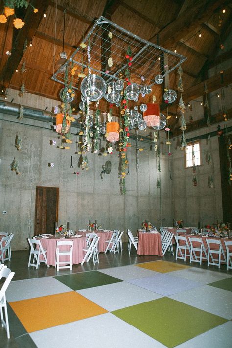 When it was time to party, the barn turned into an amazing reception space. Imagine vibrant pink tables, funky details, and a dazzling disco ball hanging over a checkered dance floor.| Image by Kelsey Justice Photography Party Dance Floor, Birthday Party Details, Garden Party Disco Wedding, Garage Wedding, Disco Ball Hanging, Wedding Wall Decor, Wedding Disco Ball Decor, Funky Wedding Decor, Hanging Disco Balls Bedroom