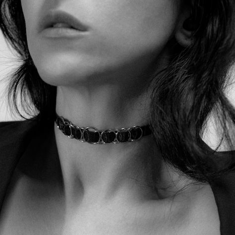 This striking black satin choker is a perfect blend of edgy sophistication and timeless allure. Crafted from a luxurious 10mm wide black satin elastic, it comfortably wraps around your neck, offering a smooth, sleek fit. The design is elevated by 13 interwoven, polished gold-tone O-rings, creating a modern yet understated aesthetic. #chokemecouture #chokers #chokernecklace #chokerstyle Satin Choker, Elegant Choker, Choker Style, O Ring, Black Satin, Choker, Choker Necklace, Gold Tones, Sleek