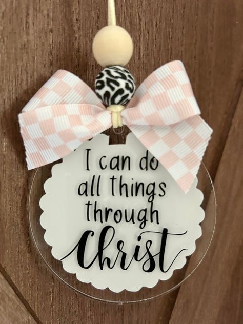 This adorable "I can do all things through Christ" car charm/rearview mirror charm is the perfect vehicle accessory and also the perfect reminder as you travel about your day!! 💕 Product comes with the following: cream color durable nylon - standard 25" from end to end  1 wood bead 1 silicone bead 3" acrylic disc pink/white checkered print bow white vinyl on back/black vinyl lettering on front *nylon cord is adjustable to suit your personal preference by tying knot at the desired length.   *this is a single sided car charm - back has white scalloped vinyl CAUTION:  Many items in this shop contain small parts and potentially present a choking hazard.  Please never allow children unattended while using these products.  All of my products should be used with adult supervision.  The buyer ass Things To Make With Vinyl, Car Hangers Rear View Mirror, Acrylic Car Charms Rear View Mirror, Homemade Charms, Car Mirror Charms, Christian Diy, Badge Reels Diy, Laser Christmas, Car Mirror Hangers