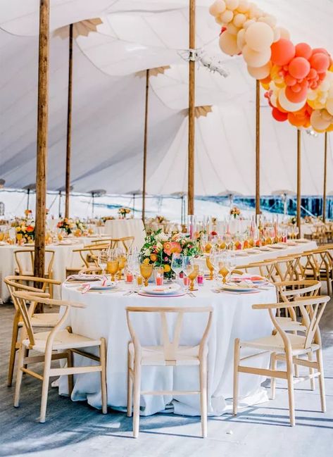 Want your wedding to pop without it being too much? Add neon pinks and bright oranges with stark white tablecloths and wooden wishbone chairs. The look is playful, inviting, and perfect for a summer wedding. See more stunning round table wedding décor ideas at the link. // Photo: Meg Smith Photography Wedding Table Decorations Round, Round Table Decor Ideas, Round Wedding Table Decorations, Summer Wedding Table Decor, Round Table Wedding, Round Table Centerpieces Wedding, Wedding Tablescapes Round, Colorful Wedding Centerpieces, Round Table Centerpieces