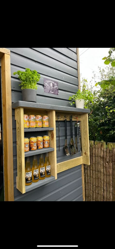 BBQ RACK what better way to store your tools and sauces than with this bar:) This rustic handmade rack has shelves for sauces, glasses, beers and hanging space with hooks.  It is easy to fix to a fence or brick, wherever your BBQ area is!  Could even be used for gardening accessories too! Somewhere to hang your gloves and trowel, whilst having a well earned break. It can just as easy be hung in a kitchen or dining room for use as you choose. Made from pressure treated whitewood FSC approved. Approximate size give or take a cm. Height 69.5cm x Width 95cm x Depth 15cm. The shelves are 2x 15.5cm and 1x 28cm. (height) Please note that while we choose pieces/cuts of wood carefully for building our products, it will feature knots and other naturally occurring defects, if for whatever reason you Bbq Wall Ideas, Small Bbq Area Ideas Balcony, Garden Shelving Outdoor, Outdoor Spice Rack Ideas, Outdoor Bbq Utensil Storage Ideas, Outdoor Grill Tool Storage, Small Bbq Area Ideas Outdoor Diy, Outdoor Bbq Storage Ideas, Outdoor Kitchen Shelves