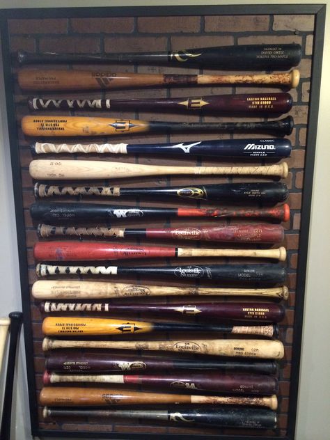 Baseball bats mounted to a laminate piece of wall. Displays my husbands used bats. Sports Room Man Cave, Baseball Bat Display, Bat Display, Baseball Bedroom, Bat Decorations, Baseball Wall, Bat Wall, Hanging Bat, Walton Family