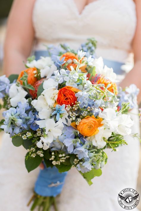 Seasonal spring flowers in shades of bright orange and soft blue. Blue Orange And White Bouquet, Blue Orange Sunflower Wedding, Tangerine And Blue Wedding, Prom Flowers Orange Dress, Blue Orange Bouquet, Orange Spring Wedding, Orange Blue Wedding Flowers, Blue And Orange Wedding Bouquet, Blue And Orange Flower Arrangements