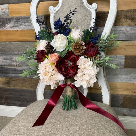 "Stunning Holiday bouquet in Burgundy, Navy and blush. This bouquet is made with high quality silk flowers consisting of peonies, roses, hydrangeas, berries and evergreen. It has all the elegance, beauty and romance you could want and will complement and wedding dress! Each floral arrangement is handmade with great attention to detail and fine craftsmanship. Bouquets are finished with ribbon color of your choice. You can be sure to love the product you receive and it will last and be beautiful for years to come!   *Attention* (Pictures show 13-14\" bride bouquet) -most popular size This bouquet can be customized to your liking and needs. If you would like a different color palette, different  accent or different type of flowers I am very accommodating. I love to work with brides to make yo Bridal Bouquet Winter, Navy Bridal Bouquet, Burgundy Bridal Bouquet, Blush And Navy Wedding, Rose Gold Bouquet, Navy Gold Wedding, Bouquet Burgundy, Holiday Bouquet, Navy Wedding Flowers